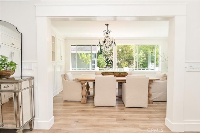 unfurnished dining area with light hardwood / wood-style floors, plenty of natural light, and a chandelier