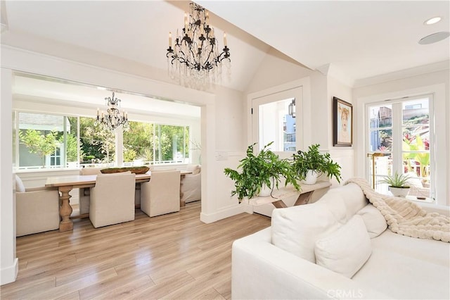 sunroom / solarium featuring lofted ceiling, a wealth of natural light, and an inviting chandelier