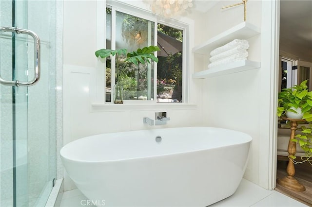 bathroom with tile patterned flooring and separate shower and tub