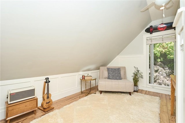 interior space featuring ceiling fan, light hardwood / wood-style flooring, and vaulted ceiling