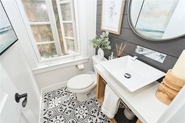 bathroom featuring toilet, tile patterned floors, and sink