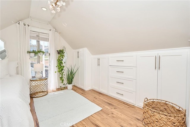 bedroom featuring light hardwood / wood-style flooring and lofted ceiling