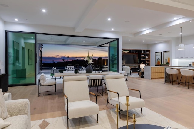 living room with beamed ceiling and light wood-type flooring