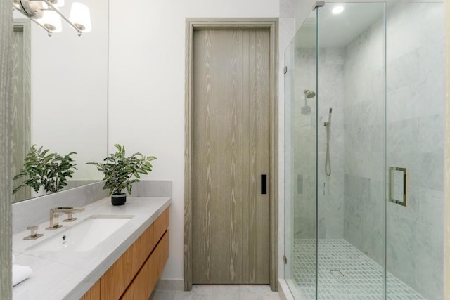 bathroom with walk in shower and vanity