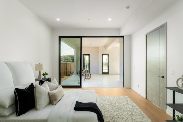 bedroom featuring light hardwood / wood-style flooring and access to outside