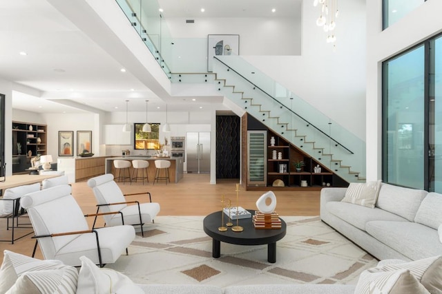 living room with a high ceiling and light hardwood / wood-style floors