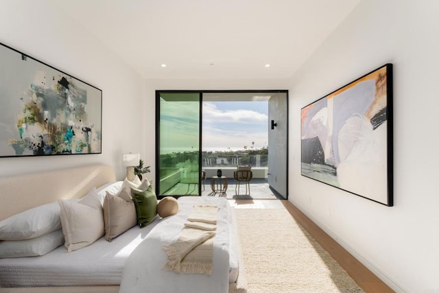 bedroom with access to outside and light hardwood / wood-style flooring