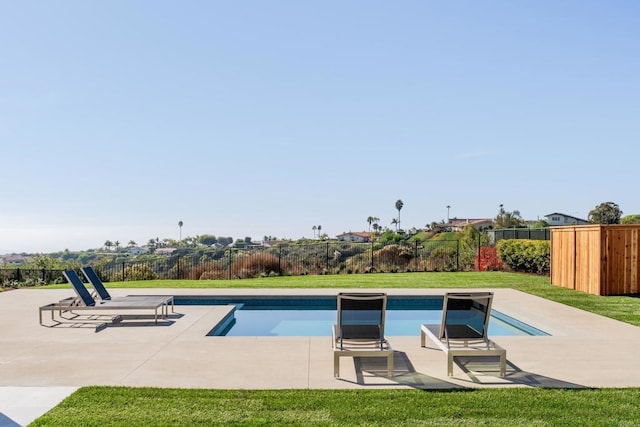 view of swimming pool featuring a yard and a patio