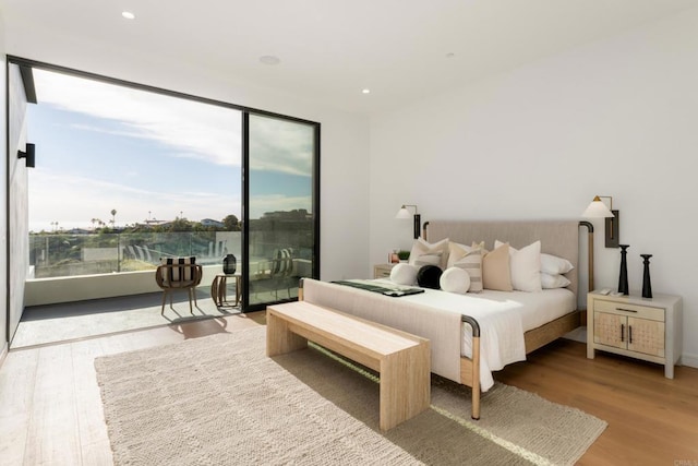 bedroom featuring wood-type flooring and access to exterior