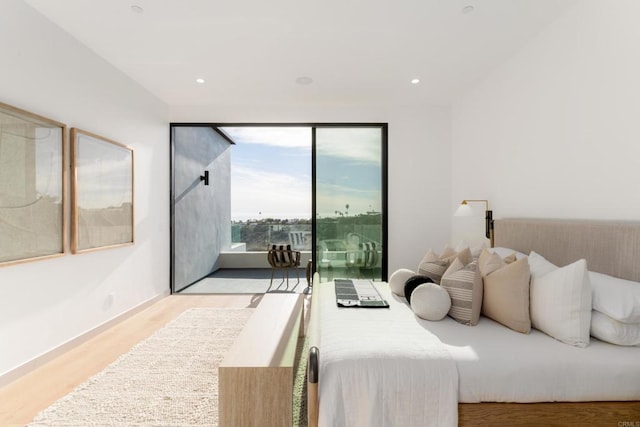 bedroom featuring access to outside and light hardwood / wood-style flooring