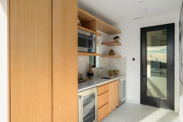 bar with wine cooler, sink, and stainless steel microwave