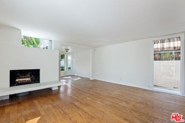 unfurnished living room featuring hardwood / wood-style flooring