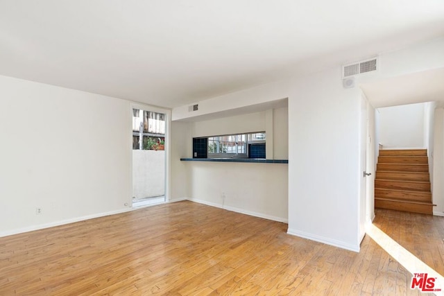 unfurnished living room with light hardwood / wood-style flooring