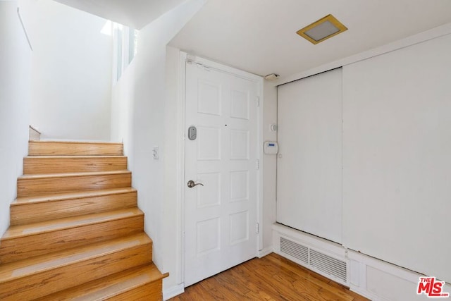 stairs with hardwood / wood-style flooring