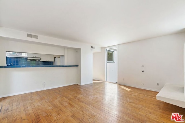 unfurnished living room featuring light hardwood / wood-style floors