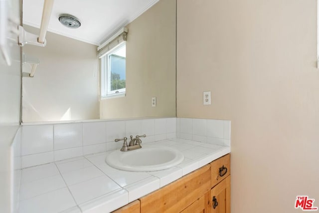 bathroom with decorative backsplash and vanity