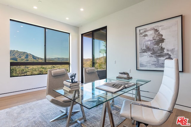 dining space with a mountain view and hardwood / wood-style flooring