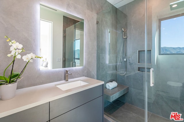 bathroom with an enclosed shower and vanity