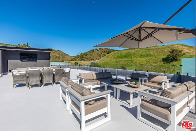 view of patio / terrace with a mountain view and outdoor lounge area