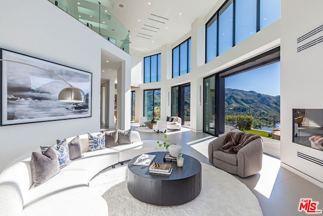 living room featuring a mountain view and a towering ceiling