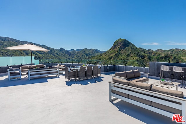 view of patio with a mountain view and outdoor lounge area