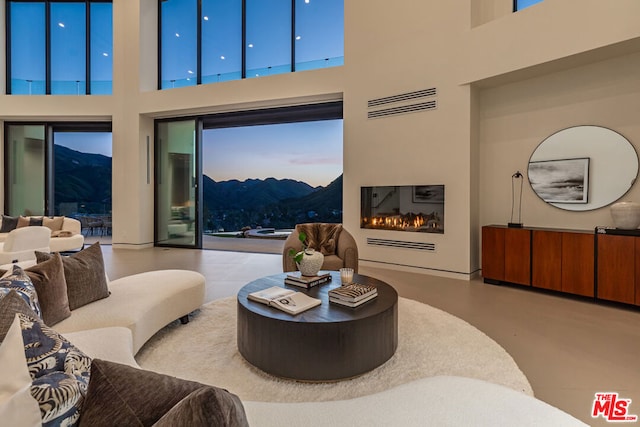 living room with a mountain view and a high ceiling