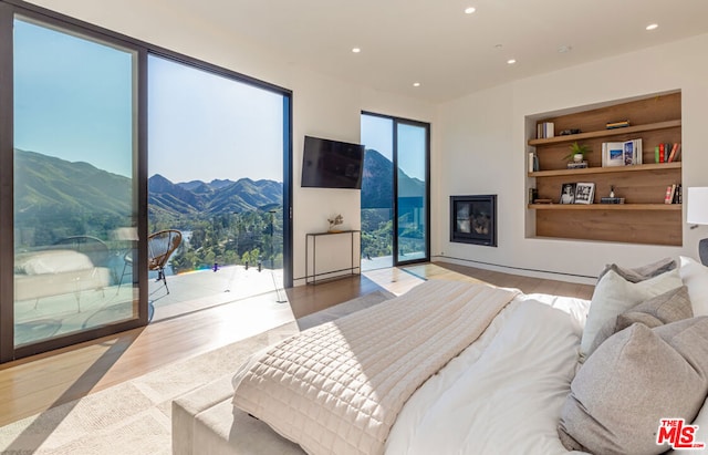 bedroom with access to outside and light hardwood / wood-style flooring