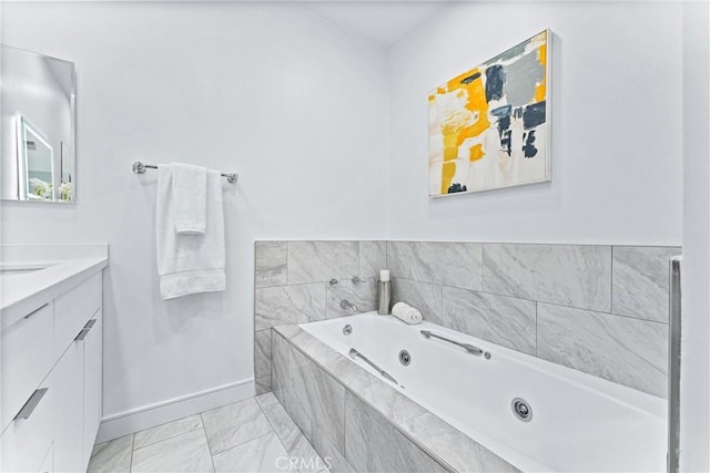 bathroom with tiled bath and vanity