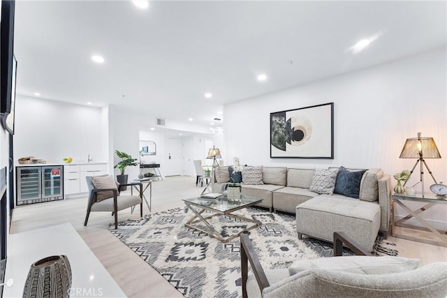 living room with beverage cooler and light wood-type flooring