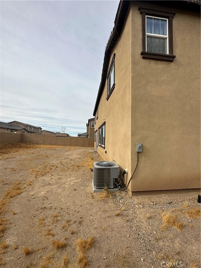 view of side of property with central AC