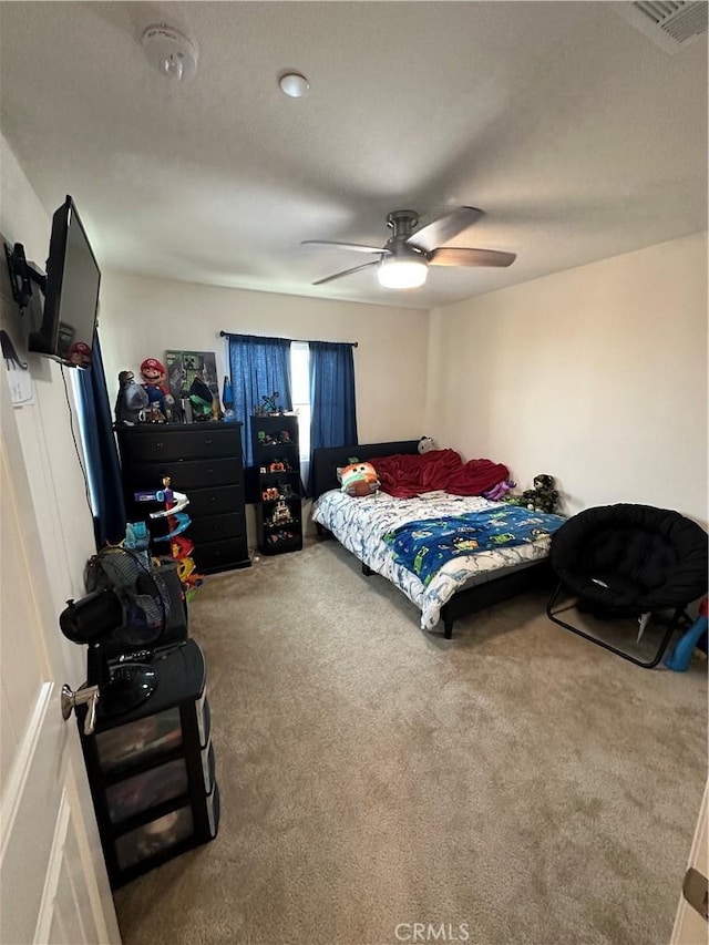 bedroom with ceiling fan and carpet