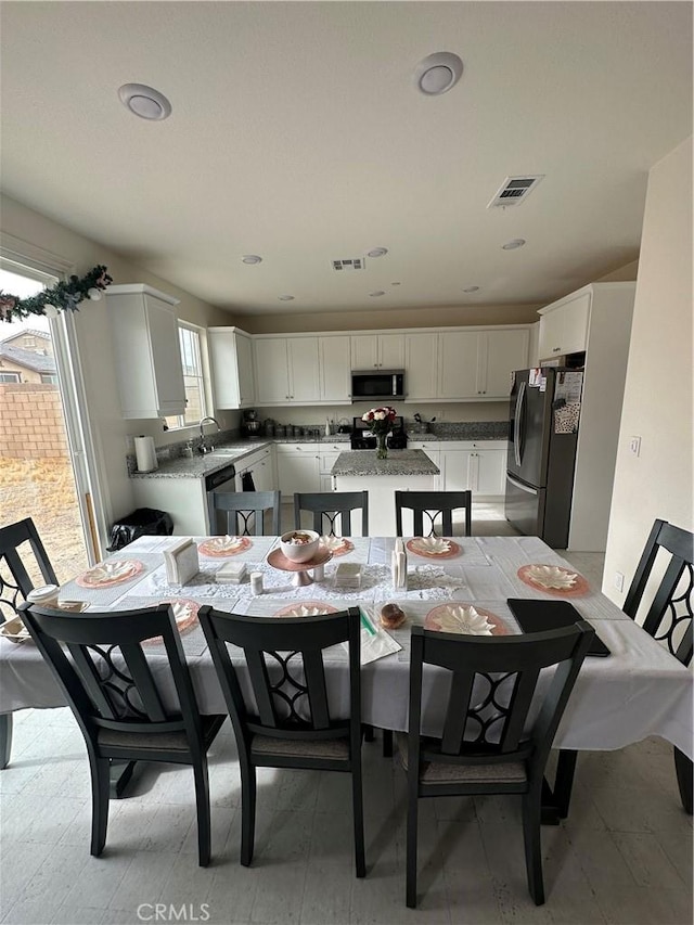 dining area featuring sink and a healthy amount of sunlight