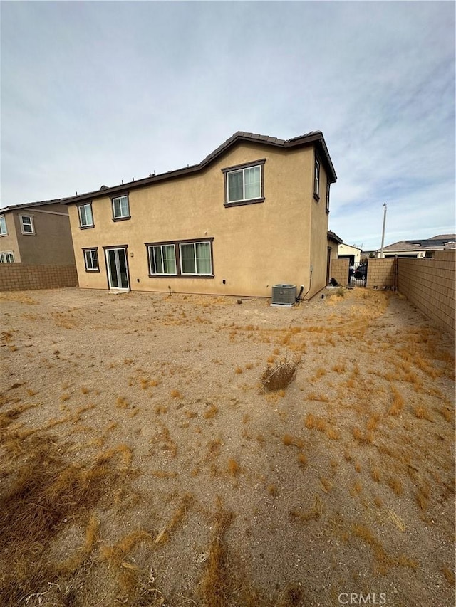 rear view of house featuring central air condition unit