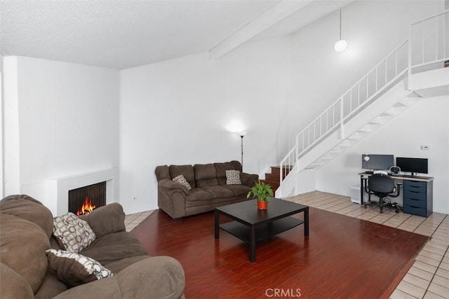 tiled living room featuring vaulted ceiling with beams