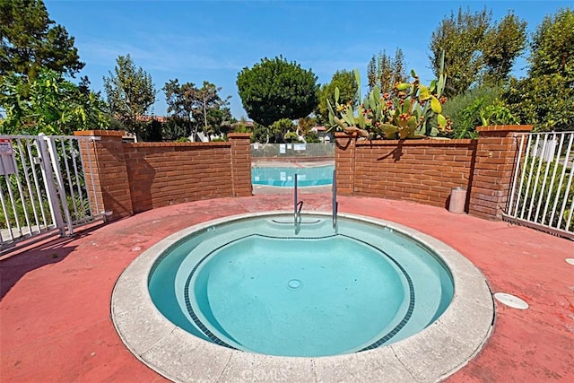 view of swimming pool with a community hot tub