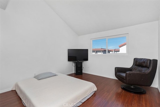 bedroom featuring lofted ceiling and dark hardwood / wood-style floors