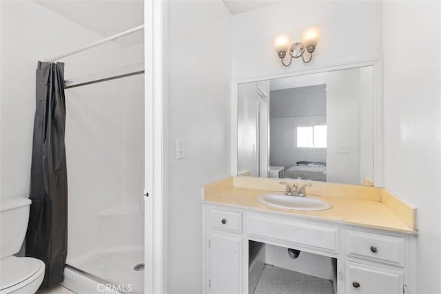 bathroom featuring toilet, vanity, and a shower with shower curtain