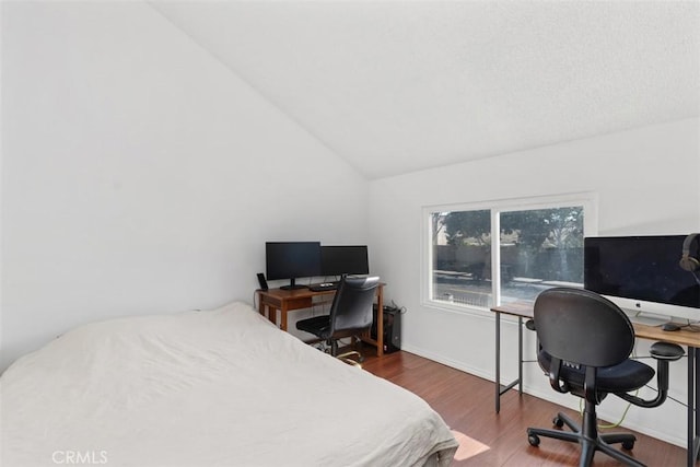 bedroom featuring lofted ceiling and wood-type flooring