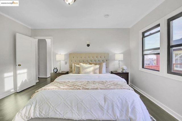 bedroom with dark hardwood / wood-style flooring