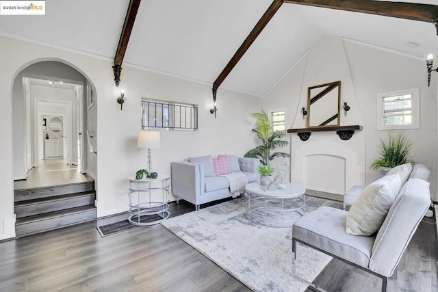 living room featuring dark hardwood / wood-style floors and vaulted ceiling with beams