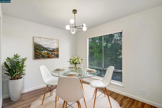 dining room featuring wood-type flooring and a notable chandelier