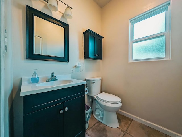 bathroom featuring vanity, tile patterned floors, and toilet