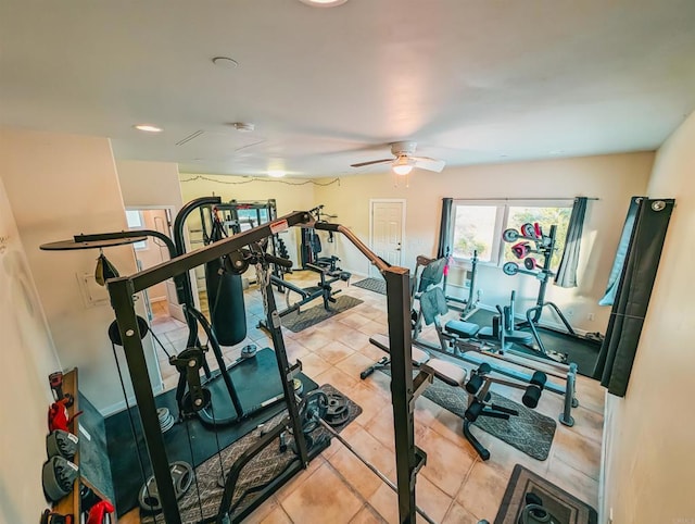 exercise room featuring light tile patterned floors and ceiling fan