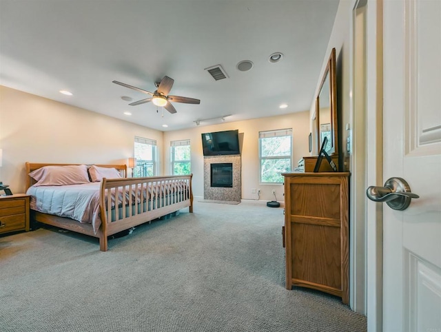 bedroom with ceiling fan and light carpet