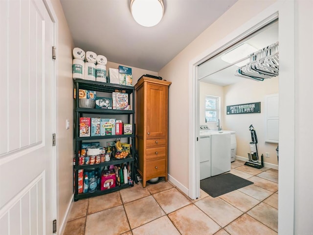 laundry area with washing machine and dryer and light tile patterned flooring