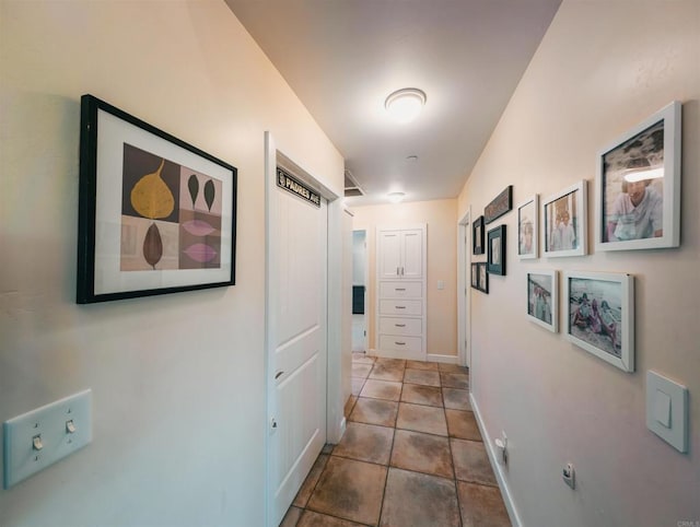 hall with tile patterned floors