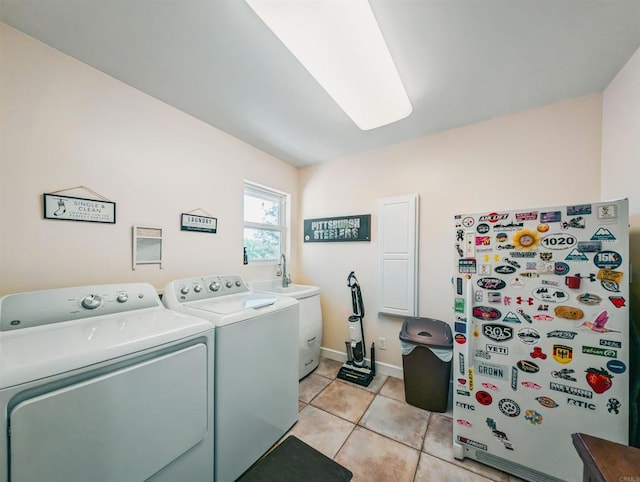 washroom with washing machine and dryer and light tile patterned floors