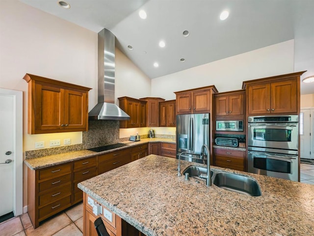 kitchen with sink, appliances with stainless steel finishes, high vaulted ceiling, light stone counters, and wall chimney exhaust hood