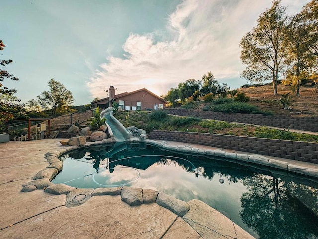 view of swimming pool with a patio and a water slide