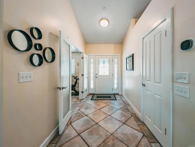 doorway to outside with light tile patterned floors